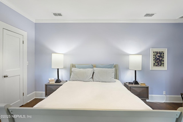 bedroom featuring ornamental molding and dark hardwood / wood-style floors