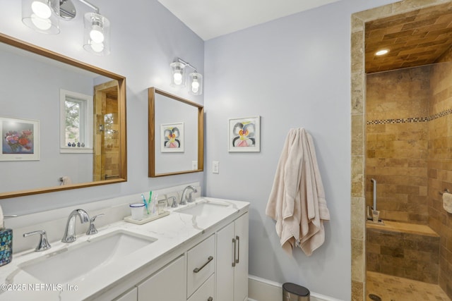 bathroom featuring walk in shower and vanity