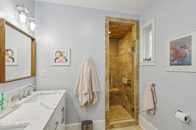 bathroom with walk in shower and vanity