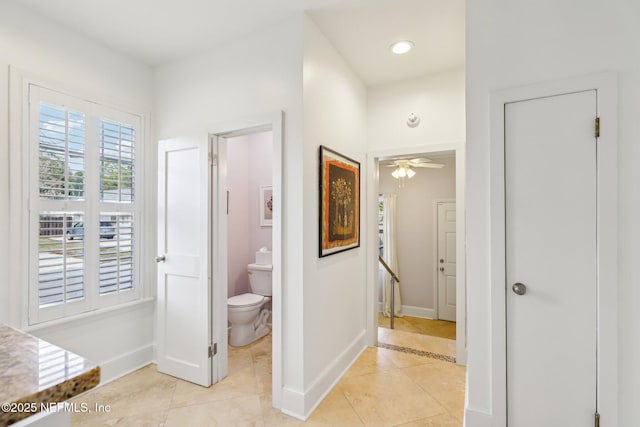 hall with light tile patterned floors