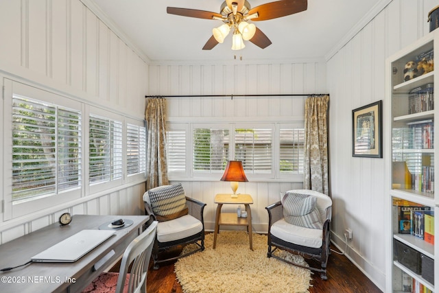 sitting room featuring dark wood-type flooring, ceiling fan, and ornamental molding