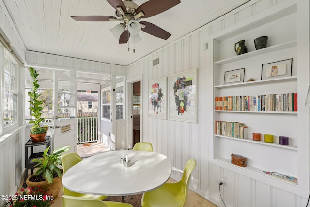 sunroom / solarium featuring ceiling fan