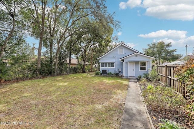 view of front of home featuring a front yard and central AC unit