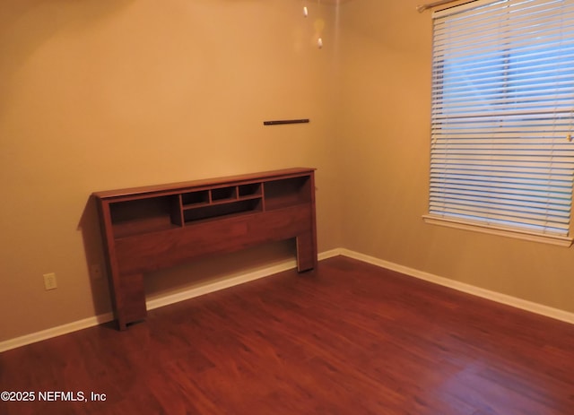 spare room with dark hardwood / wood-style flooring