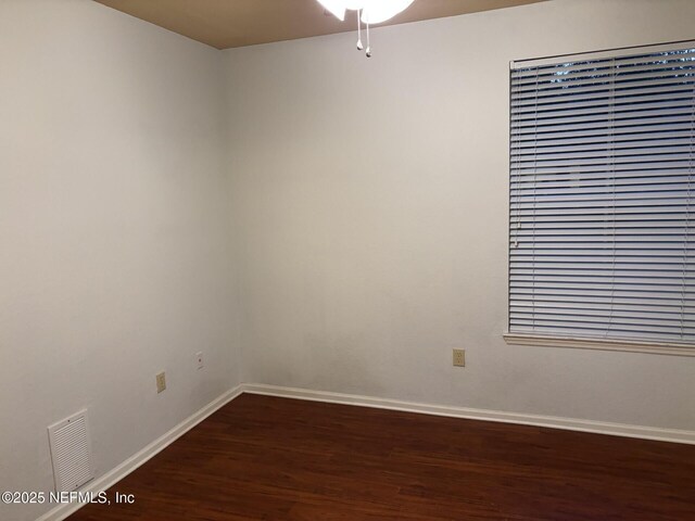 empty room featuring dark hardwood / wood-style flooring