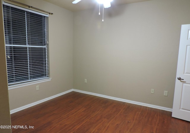 spare room with ceiling fan and dark hardwood / wood-style flooring