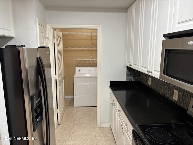 kitchen with stainless steel refrigerator with ice dispenser, white cabinetry, range with electric cooktop, and washer / clothes dryer