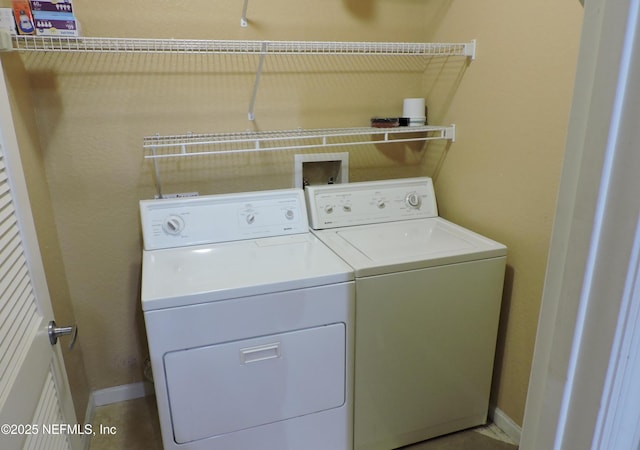 clothes washing area with separate washer and dryer