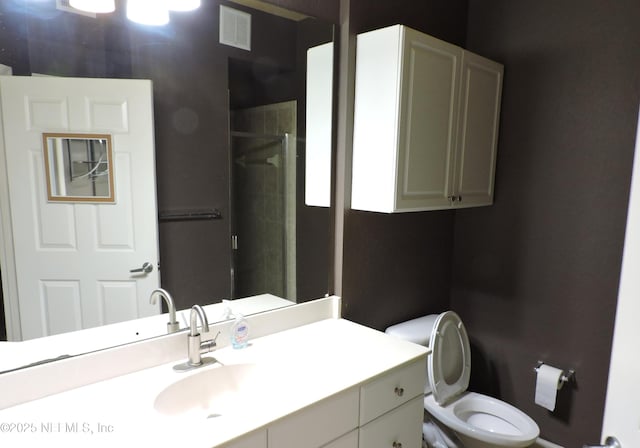 bathroom with walk in shower, vanity, and toilet