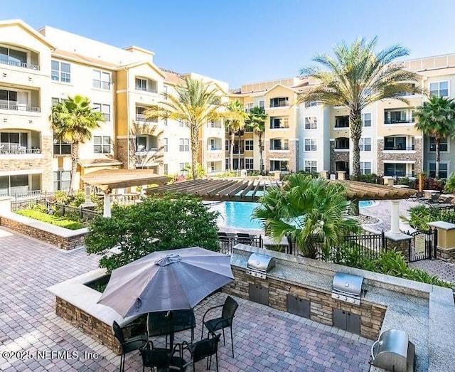 exterior space featuring a patio area, a pool, and area for grilling