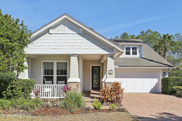 craftsman-style home with a garage and covered porch