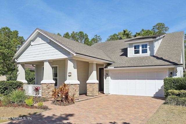 view of front of property with a garage and a porch