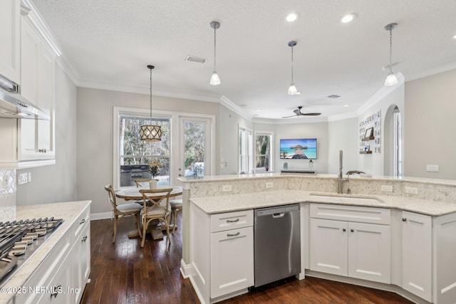 kitchen featuring sink, white cabinetry, light stone counters, hanging light fixtures, and stainless steel appliances