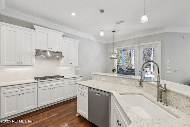 kitchen featuring white cabinetry, sink, hanging light fixtures, and appliances with stainless steel finishes