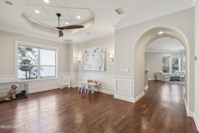 spare room with dark hardwood / wood-style flooring, coffered ceiling, ornamental molding, and ceiling fan