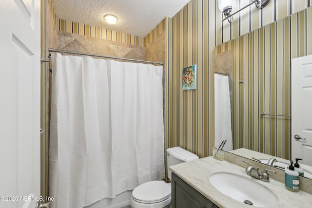 full bathroom with vanity, toilet, a textured ceiling, and shower / tub combo with curtain