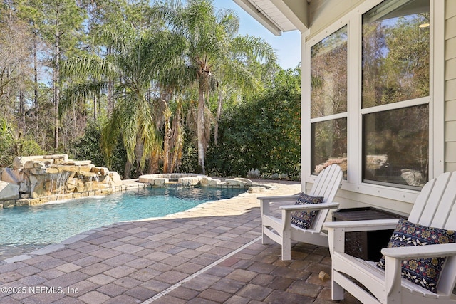 view of pool featuring an in ground hot tub and a patio