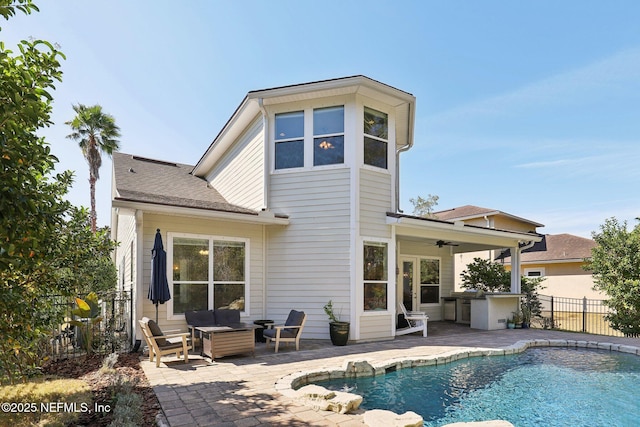 back of house with a fenced in pool, a patio, and ceiling fan