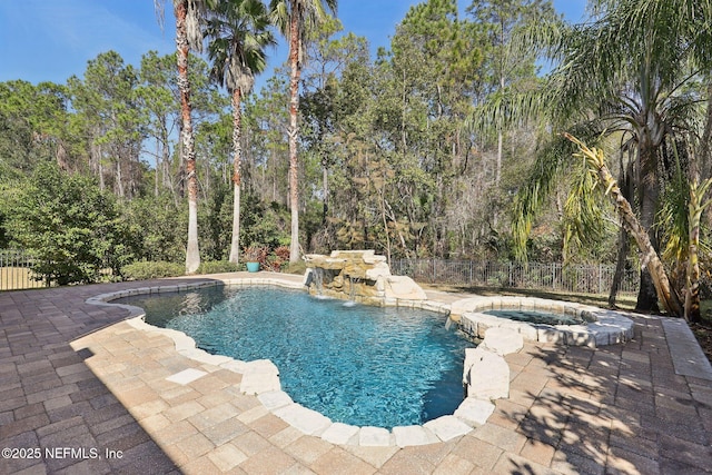 view of pool with an in ground hot tub and a patio area