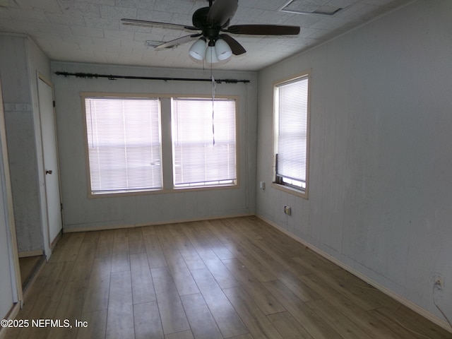 spare room featuring ceiling fan and light hardwood / wood-style flooring