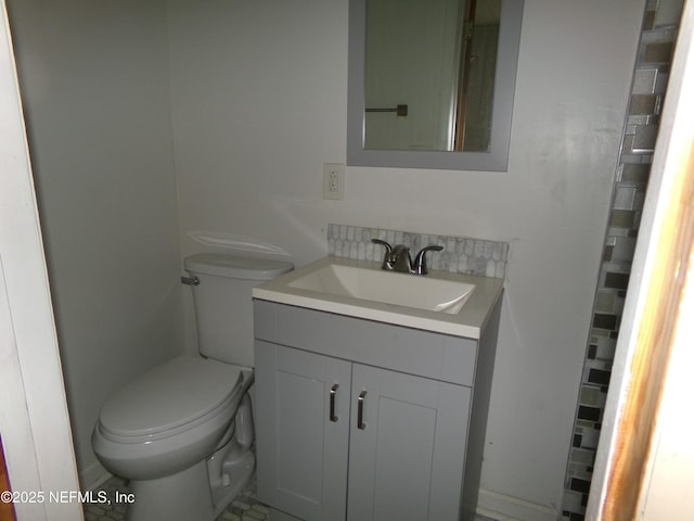 bathroom featuring toilet and vanity