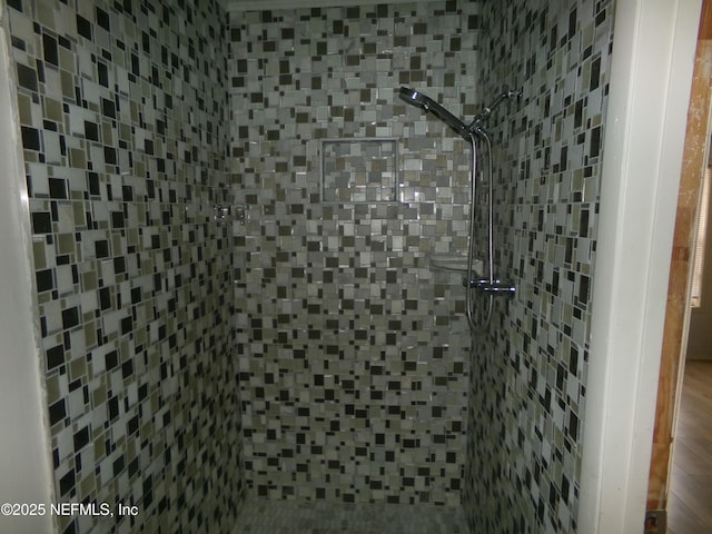 bathroom with a tile shower