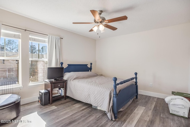 bedroom featuring ceiling fan, a textured ceiling, and hardwood / wood-style flooring