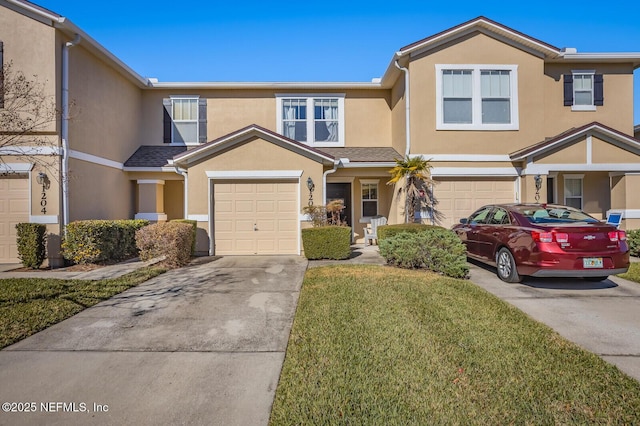 multi unit property featuring a garage and a front lawn