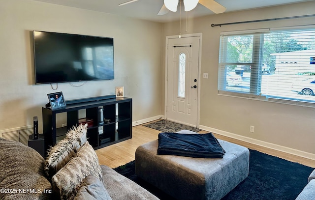 living room featuring ceiling fan and light wood-type flooring