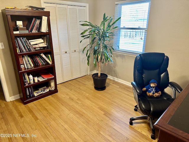 office with a healthy amount of sunlight and light hardwood / wood-style floors