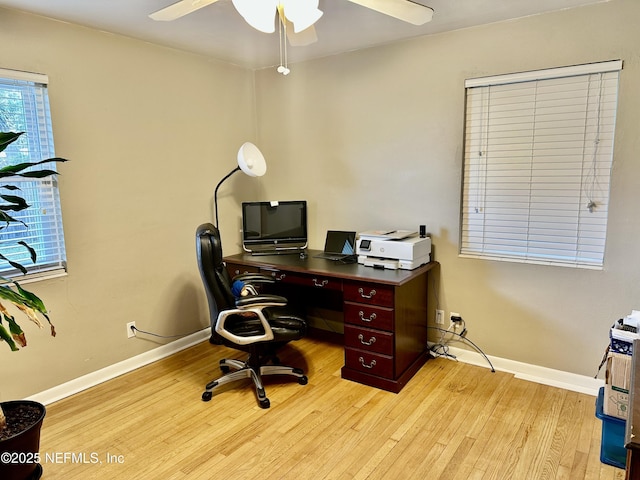 home office featuring ceiling fan and light hardwood / wood-style flooring