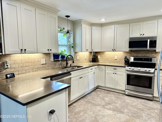 kitchen with pendant lighting, stainless steel appliances, decorative backsplash, sink, and light tile patterned flooring