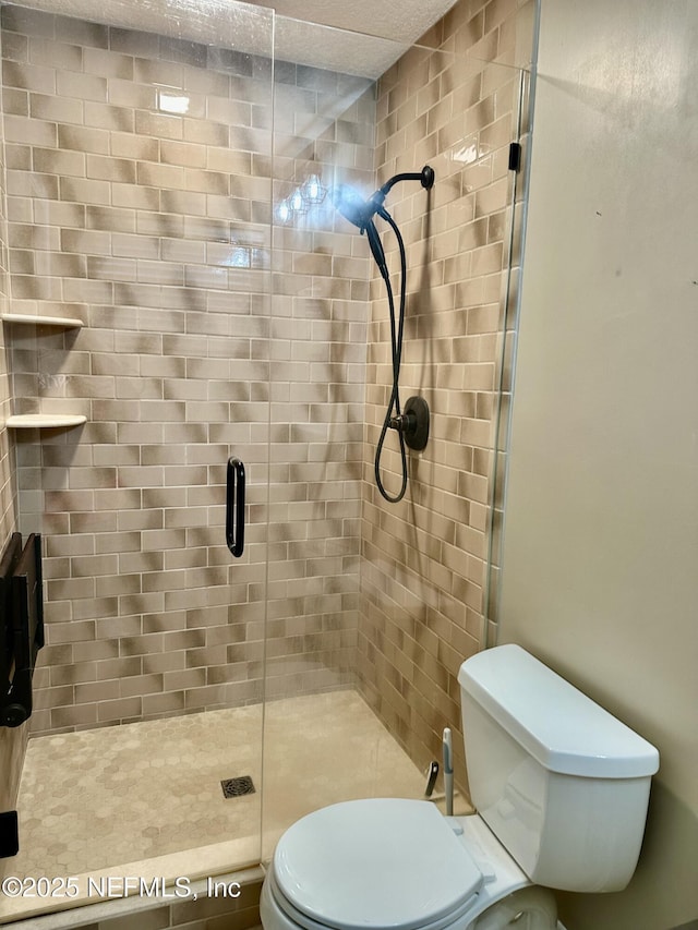 bathroom with toilet and walk in shower