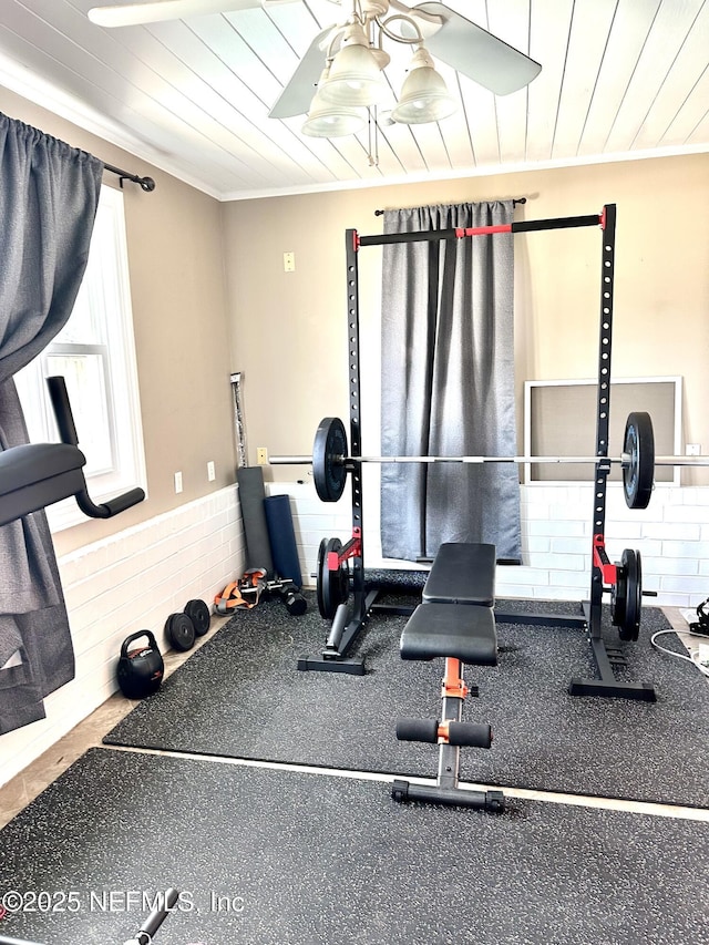 workout area with crown molding and wooden ceiling