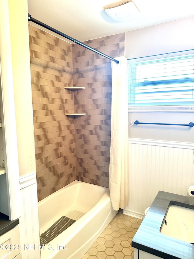 bathroom featuring tile patterned floors, vanity, and shower / tub combo