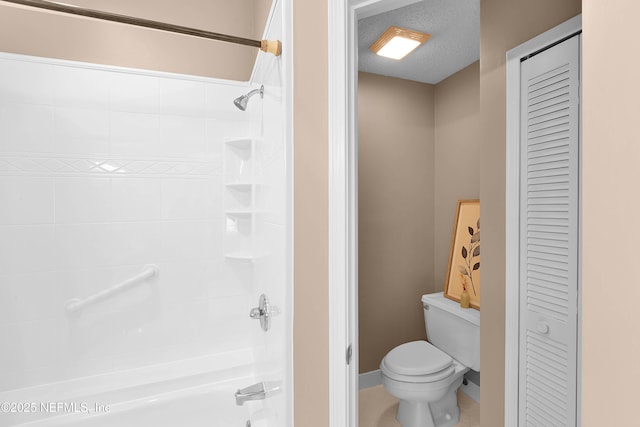 bathroom with toilet, shower / bathing tub combination, tile patterned flooring, and a textured ceiling