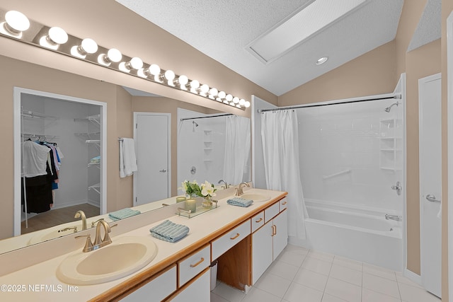 bathroom featuring lofted ceiling, shower / bathtub combination with curtain, vanity, a textured ceiling, and tile patterned floors