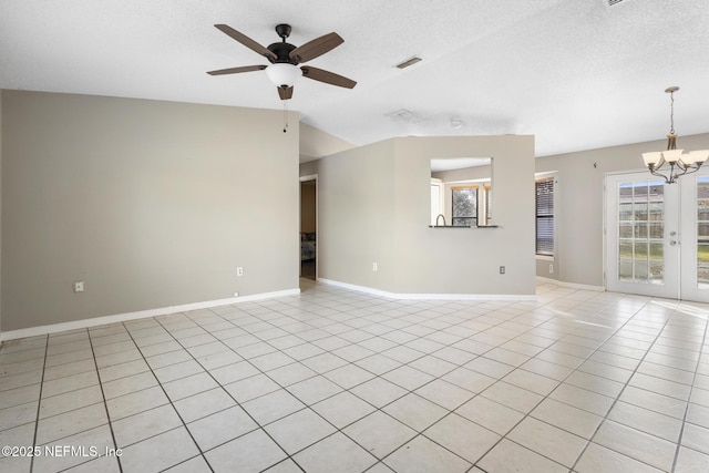 unfurnished living room featuring light tile patterned floors, french doors, ceiling fan with notable chandelier, and a textured ceiling