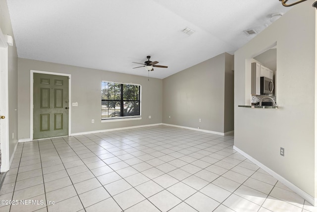 unfurnished living room with ceiling fan and light tile patterned flooring