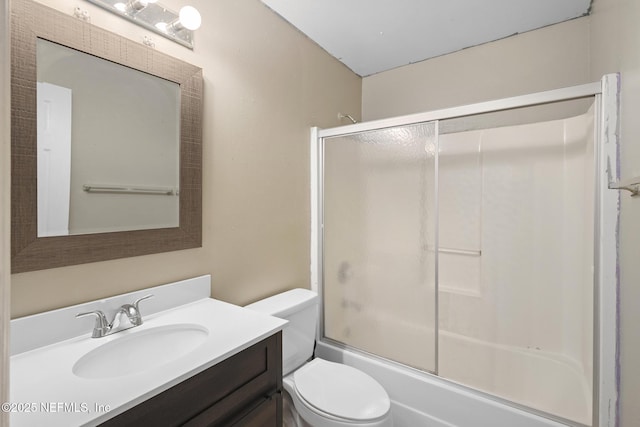 full bathroom featuring toilet, vanity, and shower / bath combination with glass door