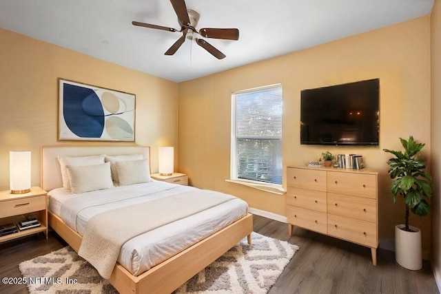 bedroom with ceiling fan and dark hardwood / wood-style floors