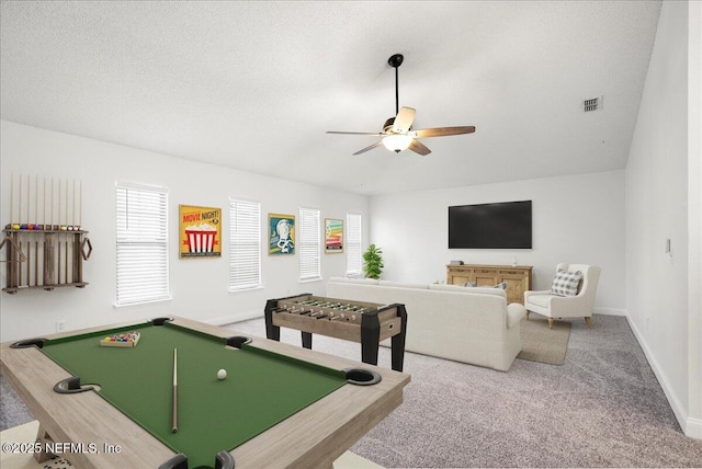 playroom featuring visible vents, baseboards, carpet flooring, a textured ceiling, and a ceiling fan