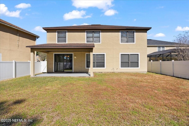 rear view of property with a yard, a fenced backyard, stucco siding, and a patio area