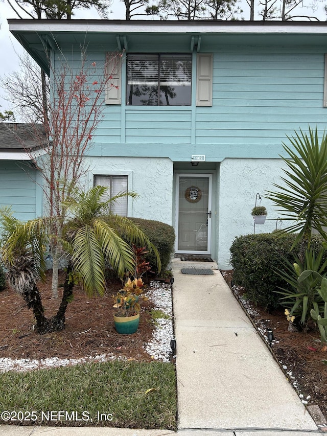 doorway to property with stucco siding