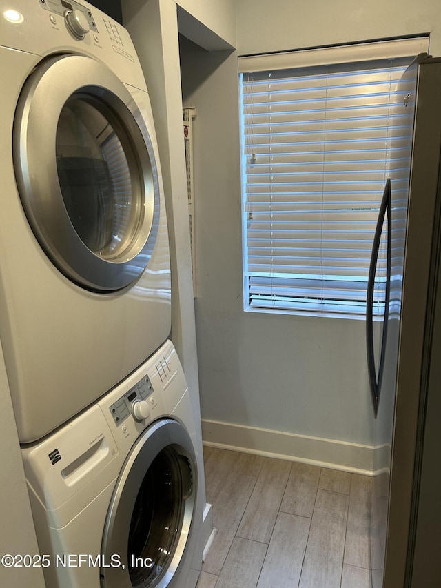 clothes washing area with stacked washer / drying machine