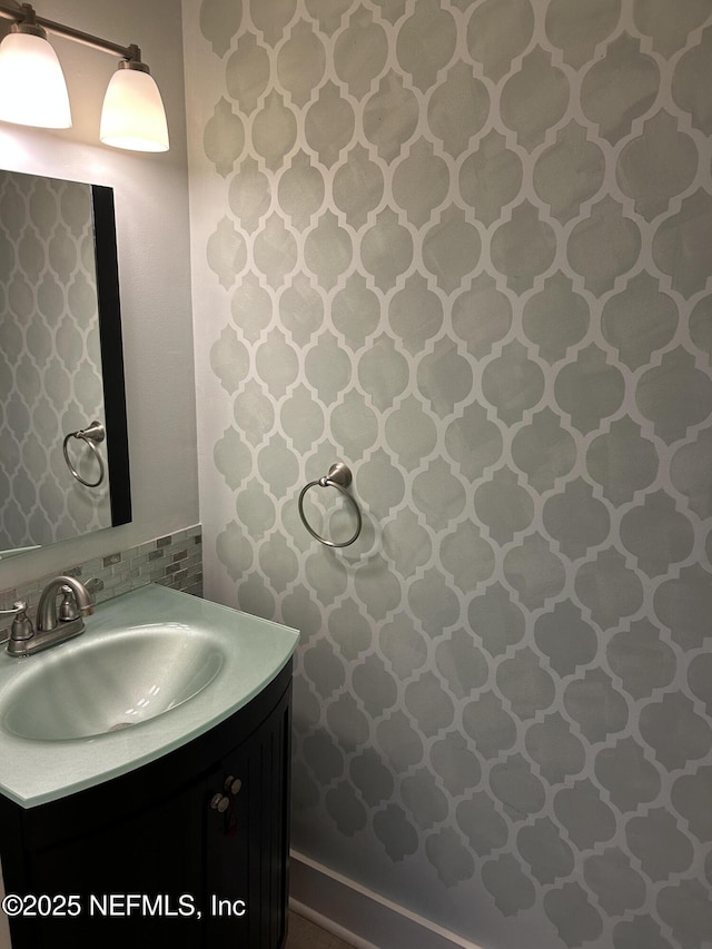 bathroom with tasteful backsplash and vanity