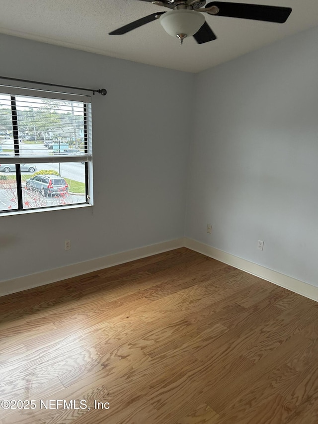 unfurnished room featuring wood-type flooring and ceiling fan