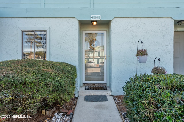 property entrance featuring stucco siding