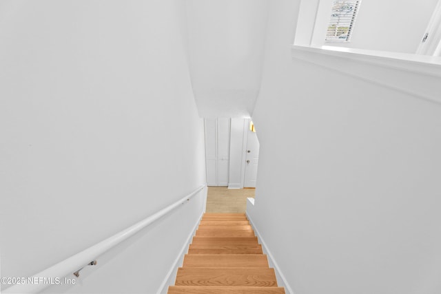 stairs with baseboards and wood finished floors