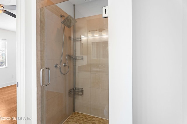 full bath with a stall shower and ceiling fan